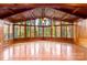Sunroom boasts vaulted wood ceilings and wall-to-wall windows showcasing scenic views at 702 Forest Hill Dr, Shelby, NC 28150