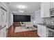 Bright dining area with hardwood floors and modern light fixture at 3010 Berry Creek Rd, Charlotte, NC 28214