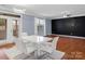 Modern dining area with white table and chairs near the kitchen at 3010 Berry Creek Rd, Charlotte, NC 28214