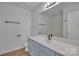 Modern bathroom with light blue vanity, updated fixtures, and a large mirror at 5346 Johnston Mill Ct, Charlotte, NC 28269