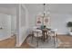 Elegant dining area with a round wooden table and four white chairs at 5346 Johnston Mill Ct, Charlotte, NC 28269