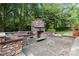 Stone outdoor kitchen with grill, fireplace, and prep area at 4520 Huntington Dr, Gastonia, NC 28056