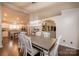 Bright dining room features a spacious table with seating for six, adjacent to the kitchen at 2707 24Th Street Ne Ct, Hickory, NC 28601