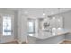 Bright kitchen entry with white cabinets and wood floors at 1031 Seven Sisters Ave, Monroe, NC 28110