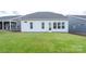 Spacious backyard with lush green grass and a home with sunroom at 1031 Seven Sisters Ave, Monroe, NC 28110