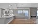 Modern kitchen with white cabinets and an island at 1031 Seven Sisters Ave, Monroe, NC 28110