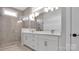 Double vanity bathroom with a walk-in shower and white cabinets at 1031 Seven Sisters Ave, Monroe, NC 28110