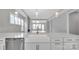 Modern kitchen features white cabinets, quartz countertops, and a farmhouse sink at 1031 Seven Sisters Ave, Monroe, NC 28110