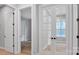 Bright hallway with white doors and hardwood floors at 1031 Seven Sisters Ave, Monroe, NC 28110