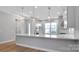 Modern kitchen with island and contemporary lighting at 1031 Seven Sisters Ave, Monroe, NC 28110