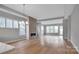 Open living room with hardwood floors and a stone fireplace at 1031 Seven Sisters Ave, Monroe, NC 28110