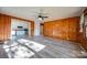 Open living room with wood paneled walls and view into kitchen at 268 Simrill St, Rock Hill, SC 29730