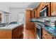Kitchen with wood cabinets, teal countertops, and stainless steel appliances at 405 7Th St, Spencer, NC 28159