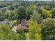 Aerial view of a charming house with a large backyard and surrounding trees at 405 7Th St, Spencer, NC 28159