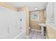 Clean bathroom with shower/tub combo, pedestal sink, and tile floor at 405 7Th St, Spencer, NC 28159