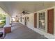 Long front porch with ceiling fans and wood floors at 405 7Th St, Spencer, NC 28159