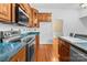 Kitchen with wood cabinets, teal countertops, and stainless steel appliances at 405 7Th St, Spencer, NC 28159