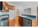 Kitchen boasts wood cabinets, teal countertops, and island at 405 7Th St, Spencer, NC 28159