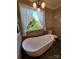 Relaxing bathroom with a free-standing tub and large window at 3486 Mason Spring Dr, Lincolnton, NC 28092