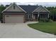 Single-story home with a two-car garage and landscaped yard at 3486 Mason Spring Dr, Lincolnton, NC 28092