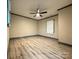 Bedroom with ceiling fan, wood-look floors and gray trim at 2216 Tate St, Charlotte, NC 28216