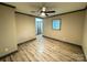 Bedroom with ceiling fan, barn door, and wood-look floors at 2216 Tate St, Charlotte, NC 28216