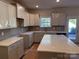 Modern kitchen features gray cabinets, quartz countertops, and a large island at 4081 Port Richmond Ave # 19, Gastonia, NC 28056