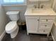 Bathroom with white vanity, dark floor tile, and a toilet at 7095 Wateredge Dr, Sherrills Ford, NC 28673