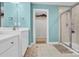 Double vanity bathroom with walk-in shower and closet at 7278 Waterwheel St, Concord, NC 28025