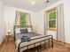 Cozy bedroom with a metal bed frame and ample natural light at 2015 Pinckney Ave, Charlotte, NC 28205