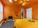 Orange bedroom with a plush yellow bed and mirrored wall at 2015 Pinckney Ave, Charlotte, NC 28205