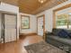 Living room with hardwood floors, a couch, and a view of the front door and windows at 2015 Pinckney Ave, Charlotte, NC 28205