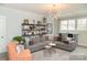 Bright game room with sectional sofa and built-in shelving at 2008 Stratford Ave, Charlotte, NC 28205