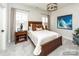 Cozy bedroom with a wooden bed frame and mountain art at 2008 Stratford Ave, Charlotte, NC 28205
