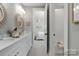 Elegant bathroom with double vanity and view into bedroom at 2008 Stratford Ave, Charlotte, NC 28205