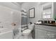 Clean bathroom with tub shower combo and gray accents at 2008 Stratford Ave, Charlotte, NC 28205