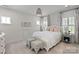 Main bedroom with a white upholstered bed and window seating at 2008 Stratford Ave, Charlotte, NC 28205
