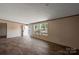 Spacious living room with wood-look floors and access to a deck at 1128 Bethesda Rd, Statesville, NC 28677