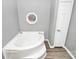 Bathroom with corner bathtub, grey walls, and wood-look flooring at 270 Cornelius Dr, Rock Hill, SC 29730