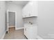 Bright laundry room with white cabinets, sink and closet at 14008 Little Spring Ct # 391, Charlotte, NC 28278