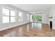 Spacious living room featuring hardwood floors, fireplace, and access to deck at 14008 Little Spring Ct # 391, Charlotte, NC 28278