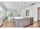 Open concept kitchen with island, stainless steel appliances, and hardwood floors at 14008 Little Spring Ct # 391, Charlotte, NC 28278