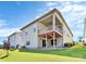 Back exterior showcasing a two-story home with deck and landscaped yard at 14008 Little Spring Ct # 391, Charlotte, NC 28278