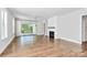 Bright living room with hardwood floors, fireplace and sliding glass doors to deck at 14008 Little Spring Ct # 391, Charlotte, NC 28278