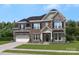 Two-story brick house with stone accents and a three-car garage at 207 Coronado Ave # 56, Matthews, NC 28104