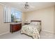 Cozy bedroom with a floral bedspread and a dresser at 1300 Reece Rd # 302, Charlotte, NC 28209