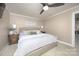 Bright bedroom featuring a king-size bed and ceiling fan at 4672 Trails End Rd, Denver, NC 28037