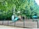 Community playground with swings, slides, and climbing structures at 13832 Cypress Woods Dr, Huntersville, NC 28078