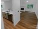 Open concept kitchen and living area with modern finishes and hardwood floors at 4826 Carnbrook Pl, Charlotte, NC 28212