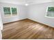 Bright bedroom with wood-look flooring and large windows at 4826 Carnbrook Pl, Charlotte, NC 28212